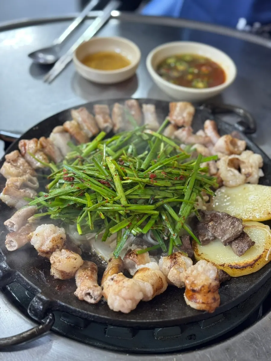 Mixed gopchang cooking on the grill