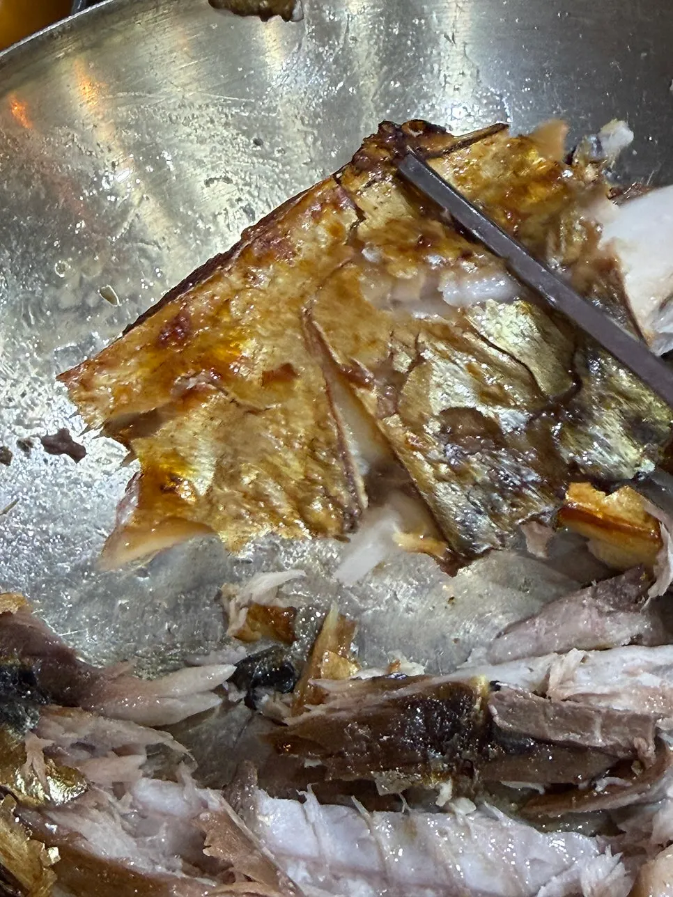 A piece of grilled mackerel placed on top of rice