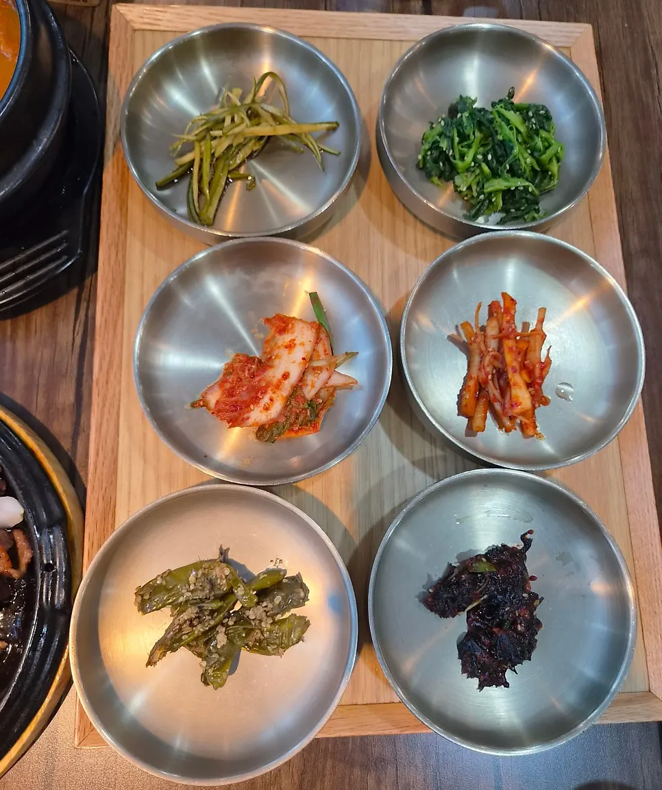Assorted Korean side dishes including namul, kimchi, and pickled vegetables