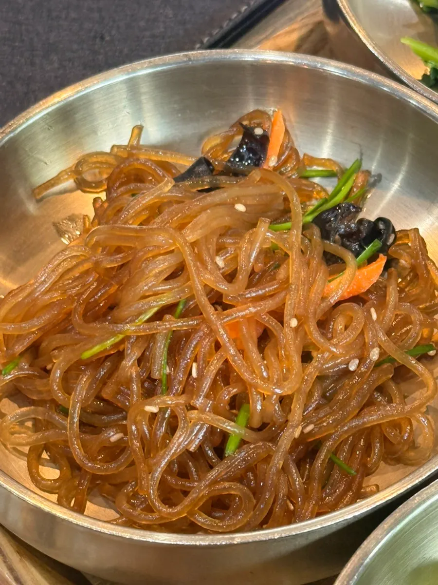 A spoonful of nurungji topped with kimchi