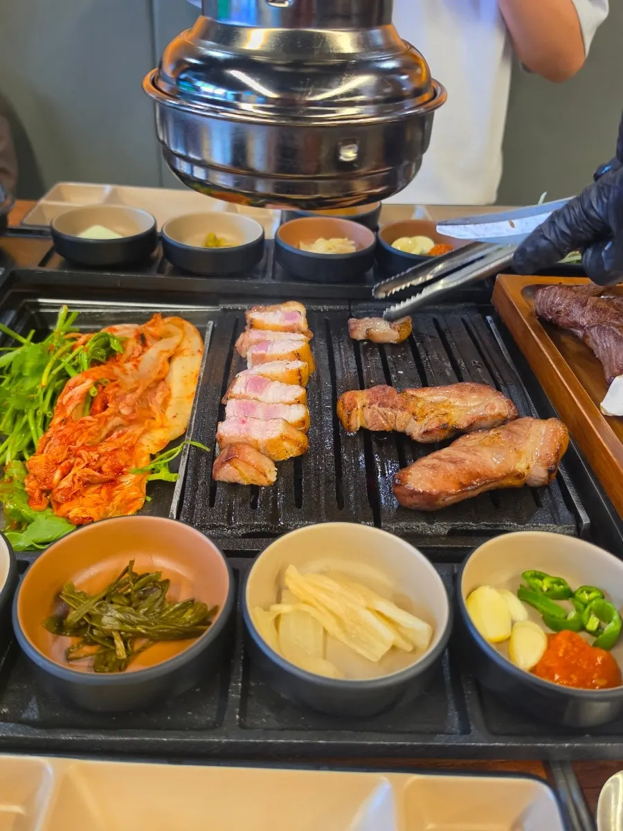 Staff member grilling meat on the plate