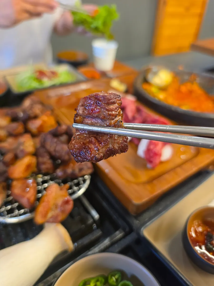 A bite of grilled meat in a lettuce wrap