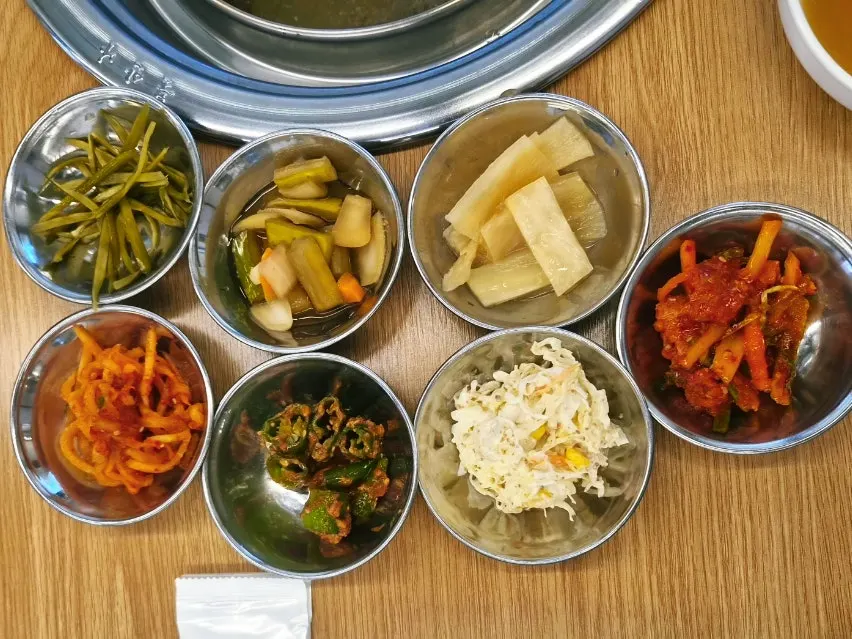 Table set with lettuce, sliced onion, and basic side dishes