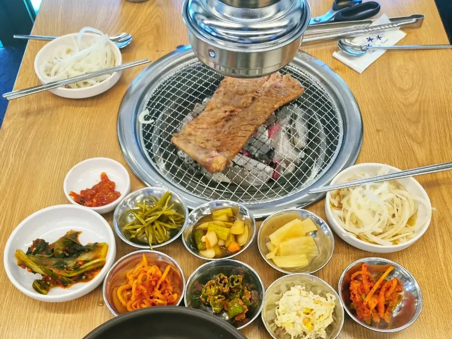 Large marinated pork ribs placed on the charcoal grill