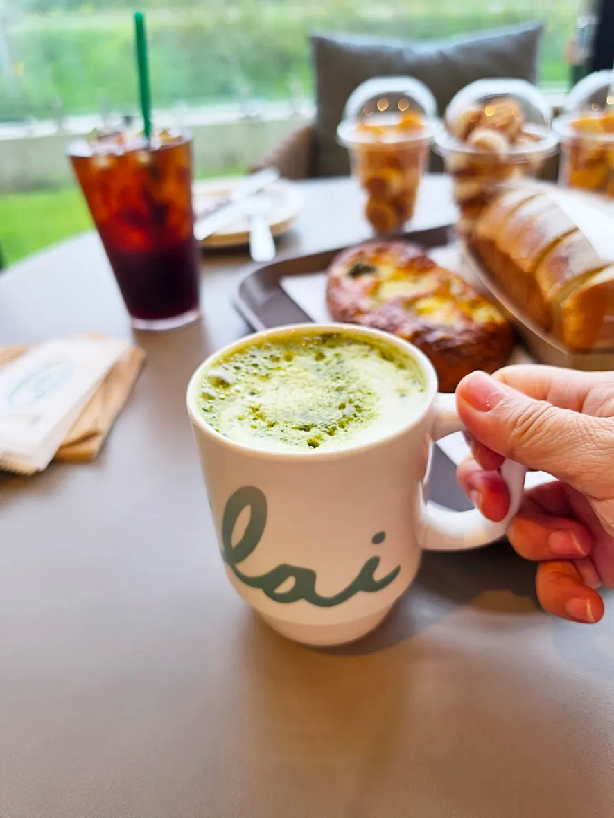 Warm matcha latte topped with green matcha powder