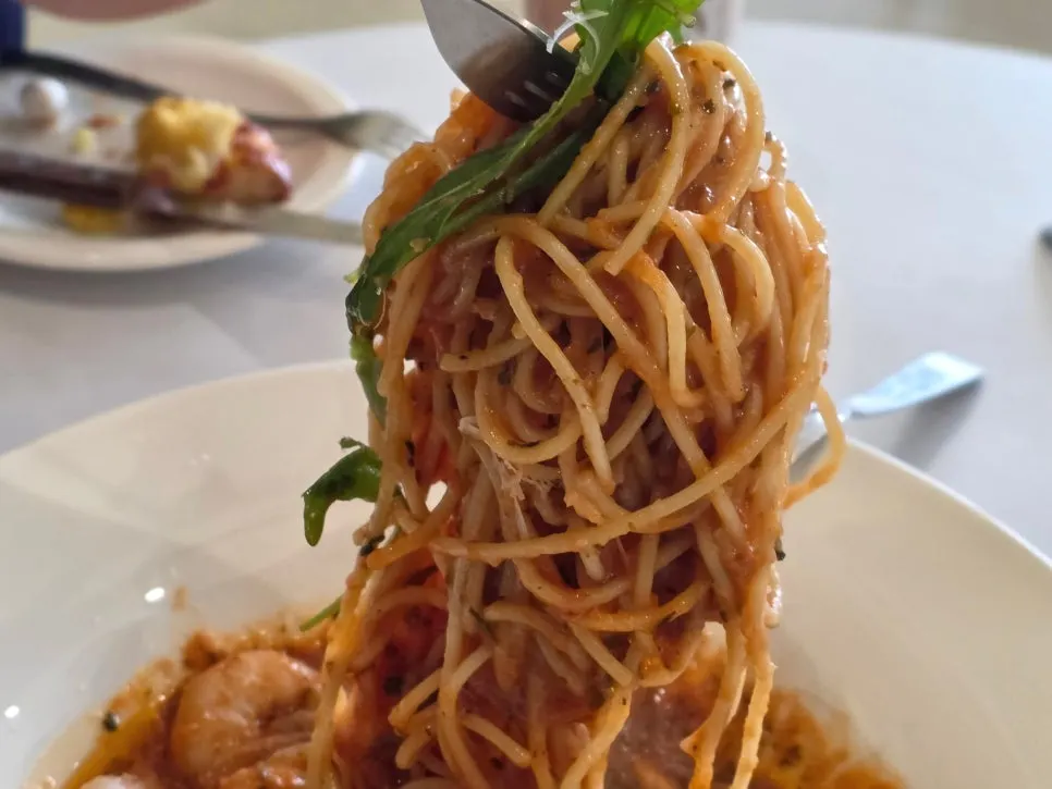 Table setting alongside the tomato pasta