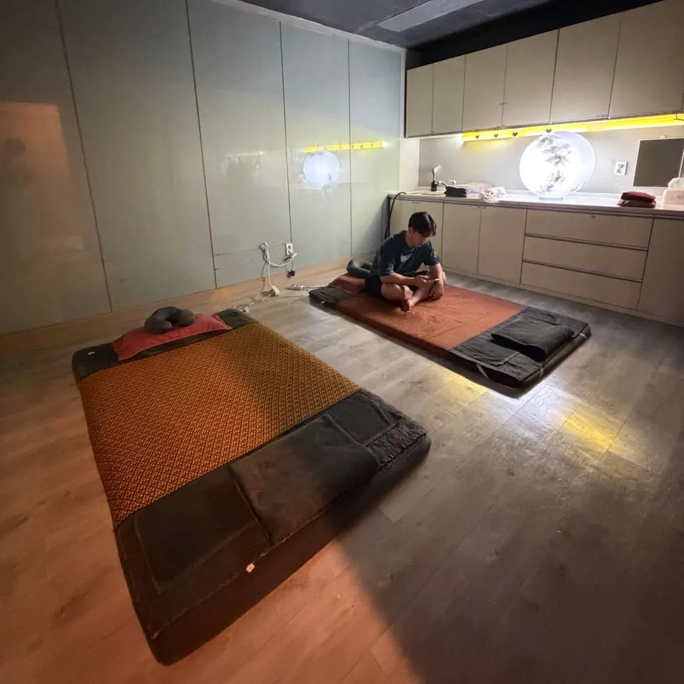 Full-body Thai massage received face-down