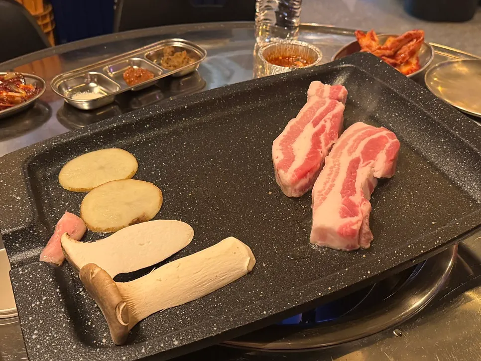 Staff grilling pork belly on the grill