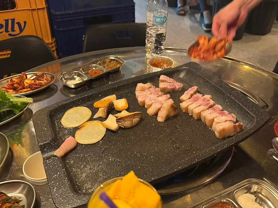 Kimchi grilled alongside pork belly on the grill