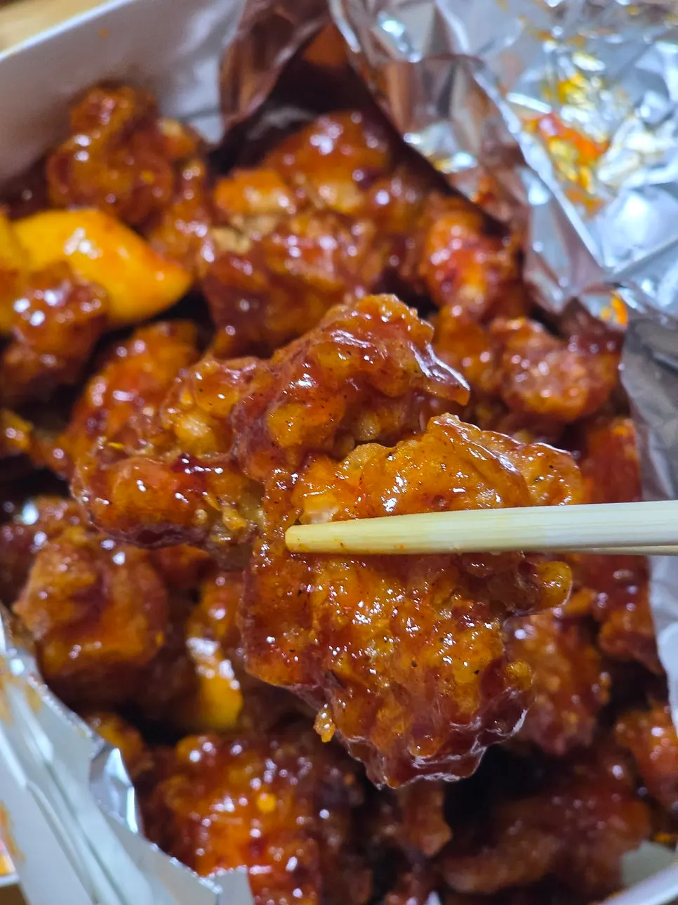 Dakgangjeong and fried gizzards in takeout containers