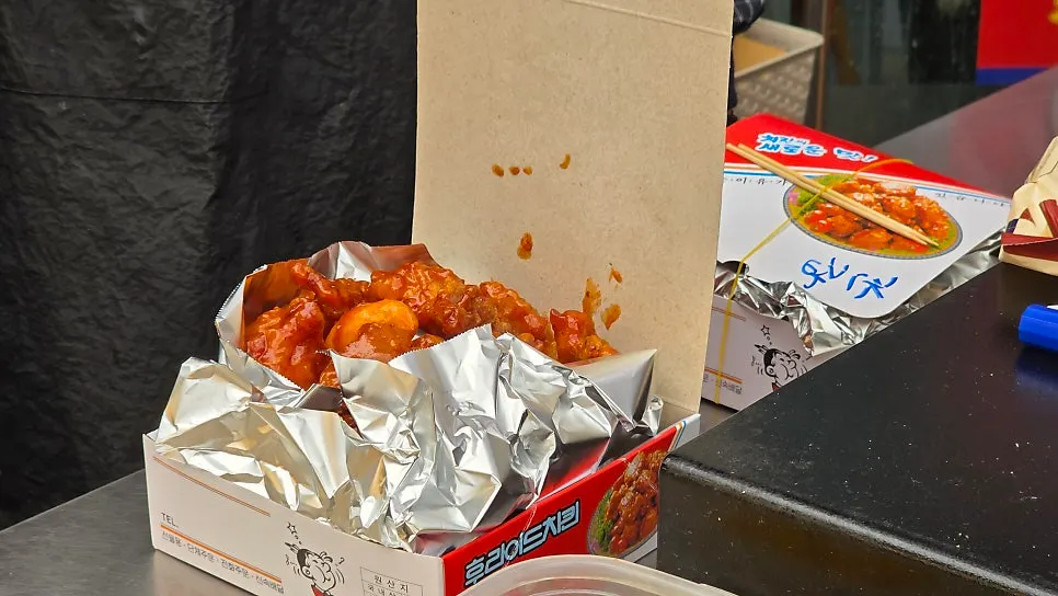 Dakgangjeong takeout box wrapped in aluminum foil