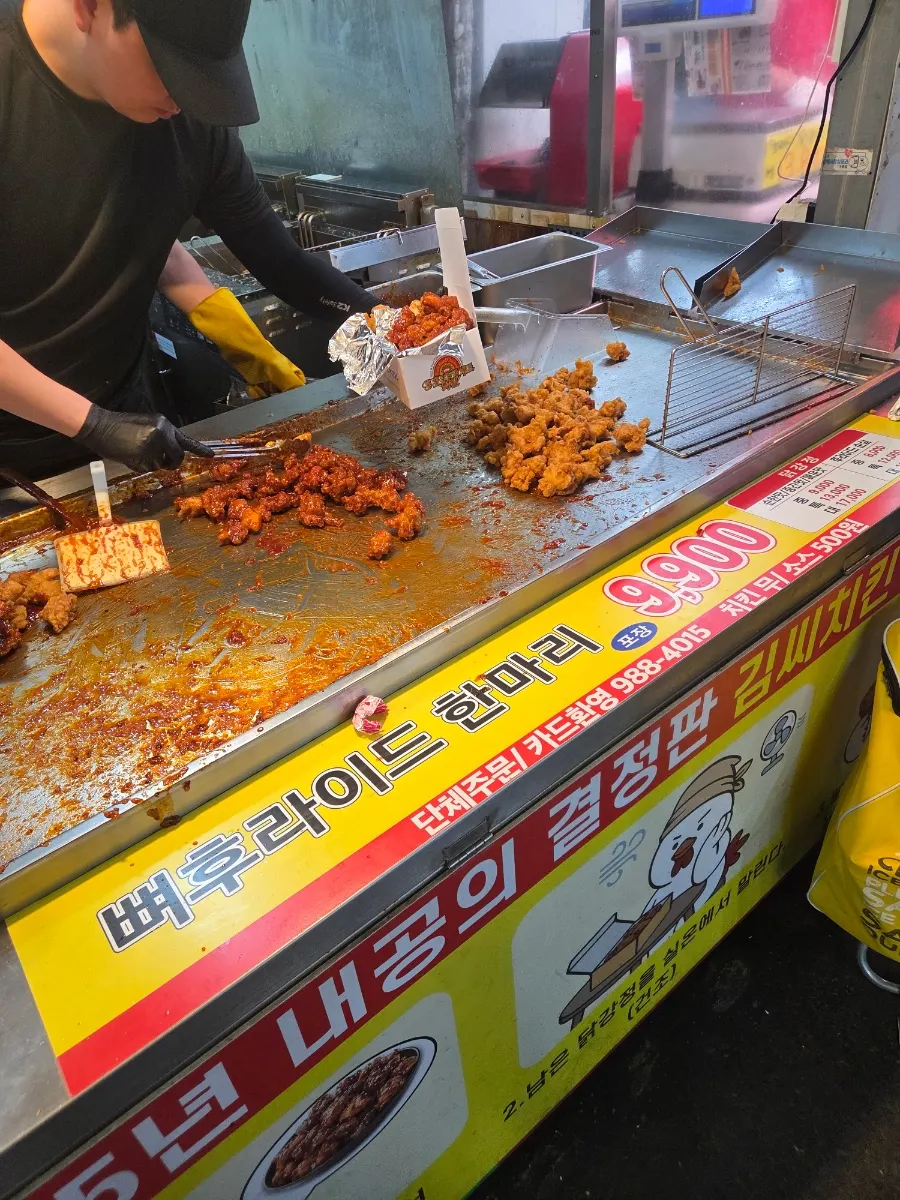 Menu board showing bone-in fried chicken and extra sauce pricing