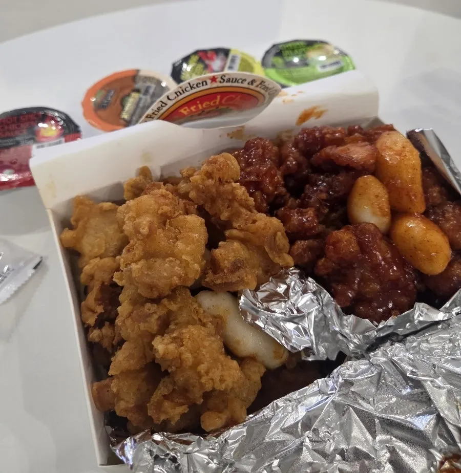 Box with dakgangjeong and boneless fried chicken side by side