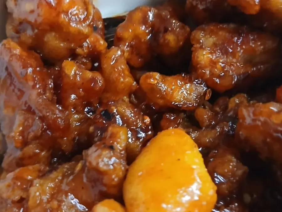 Close-up of dakgangjeong evenly coated in sauce
