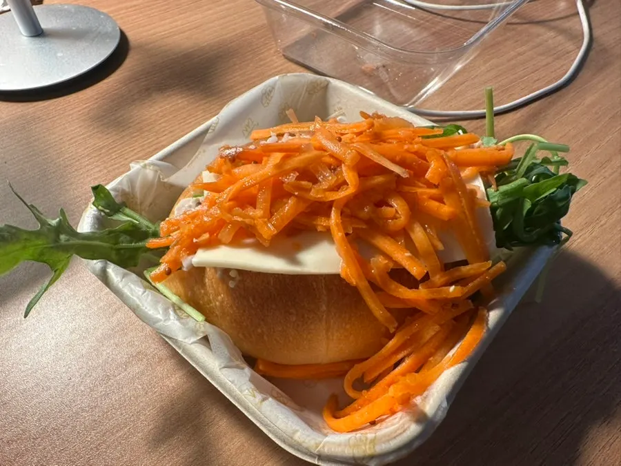 Cross-section of the chicken sandwich piled high with carrot râpée