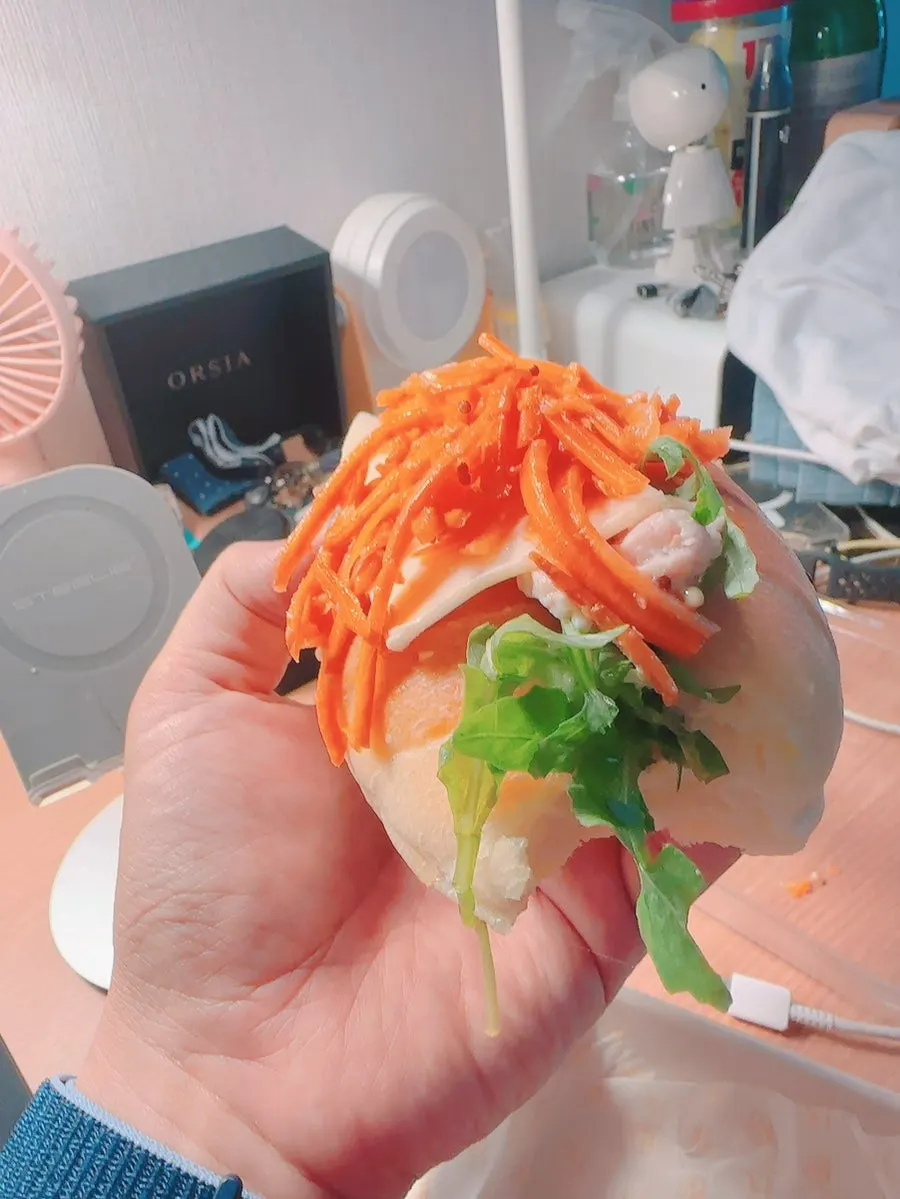 The carrot râpée chicken sandwich with a bite taken out
