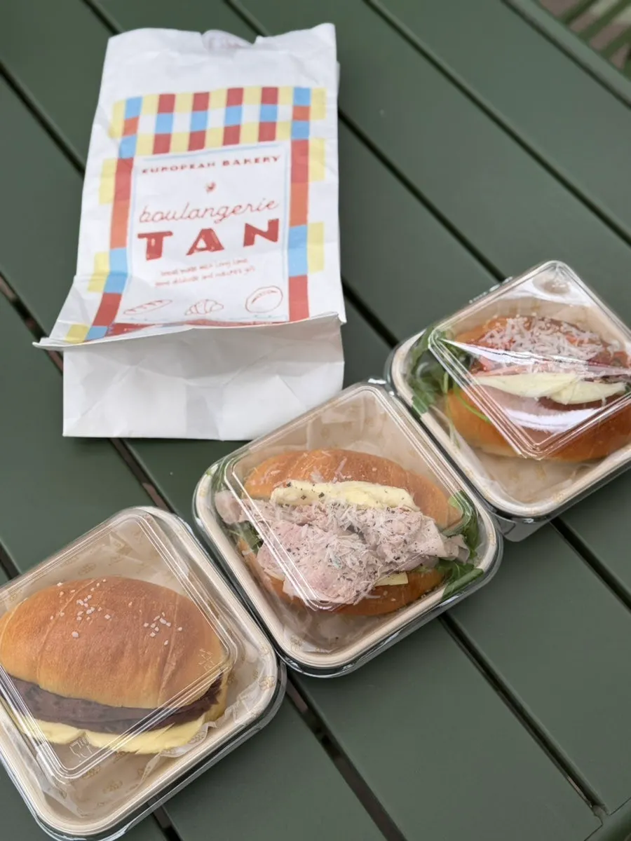 Takeout bag with Boulangerie Tan salt bread sandwiches