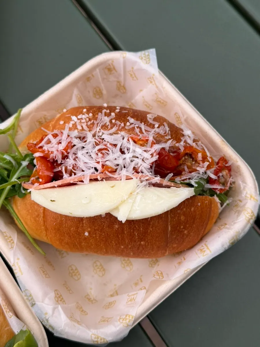 Jambon fromage salt bread with ham, cheese, and arugula