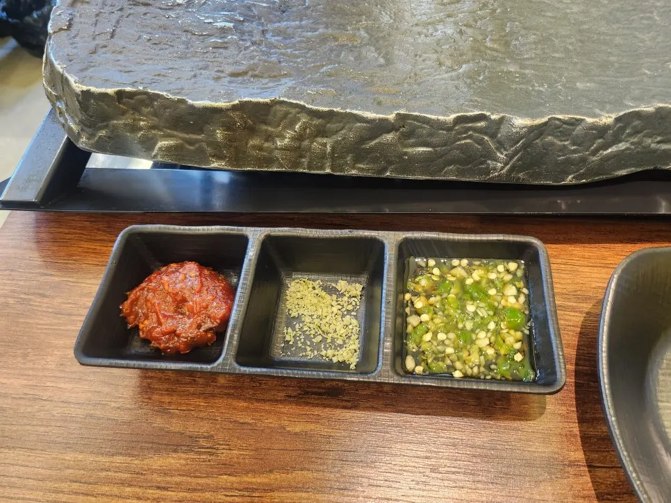 Meat and side dishes placed on the cast-iron grill