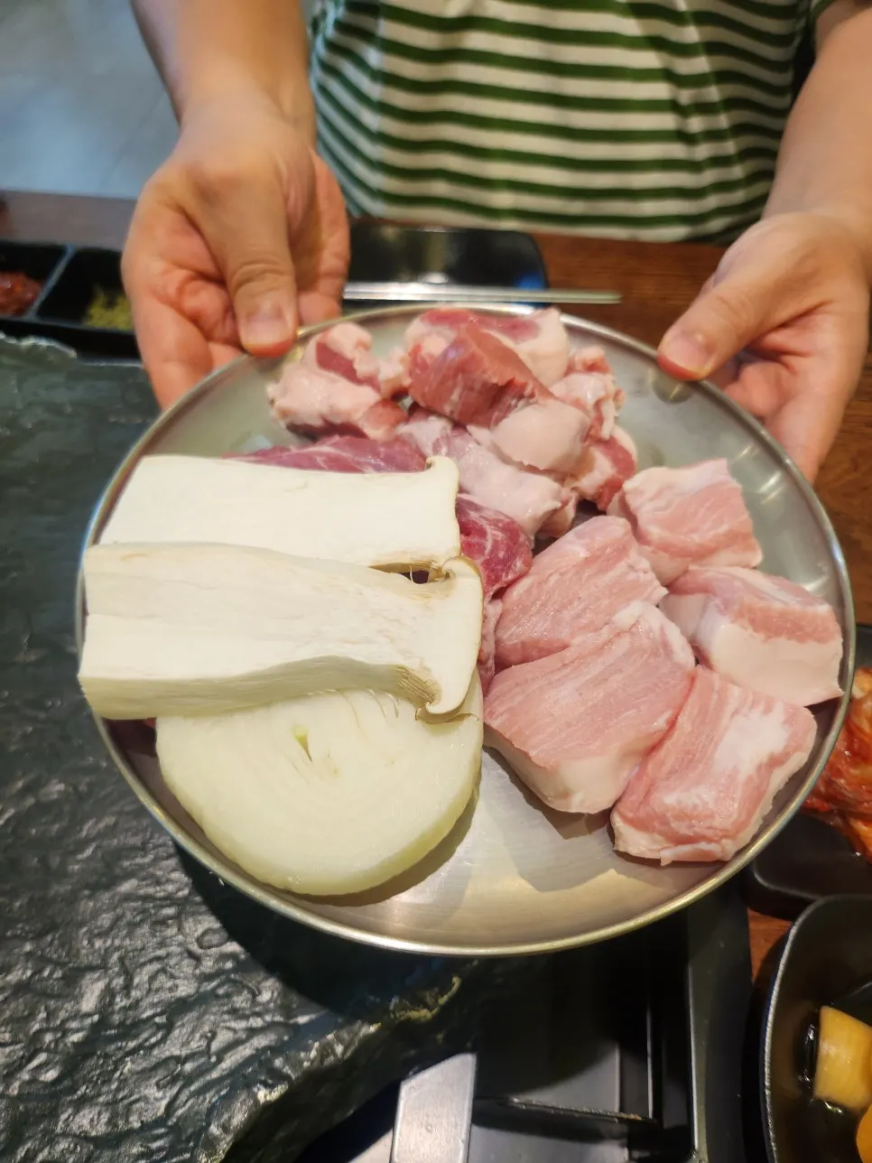 Thickly sliced, bright pink Korean pork