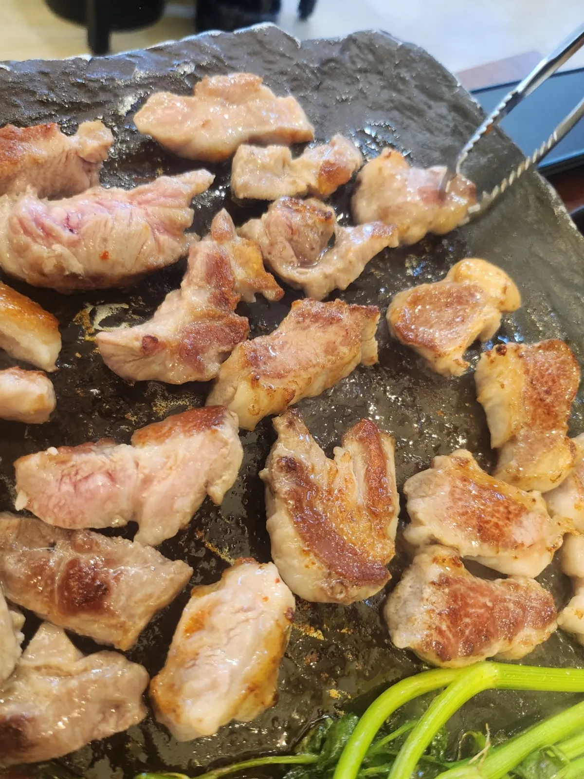 Grilled Korean pork wrapped with minari cooked in pork fat