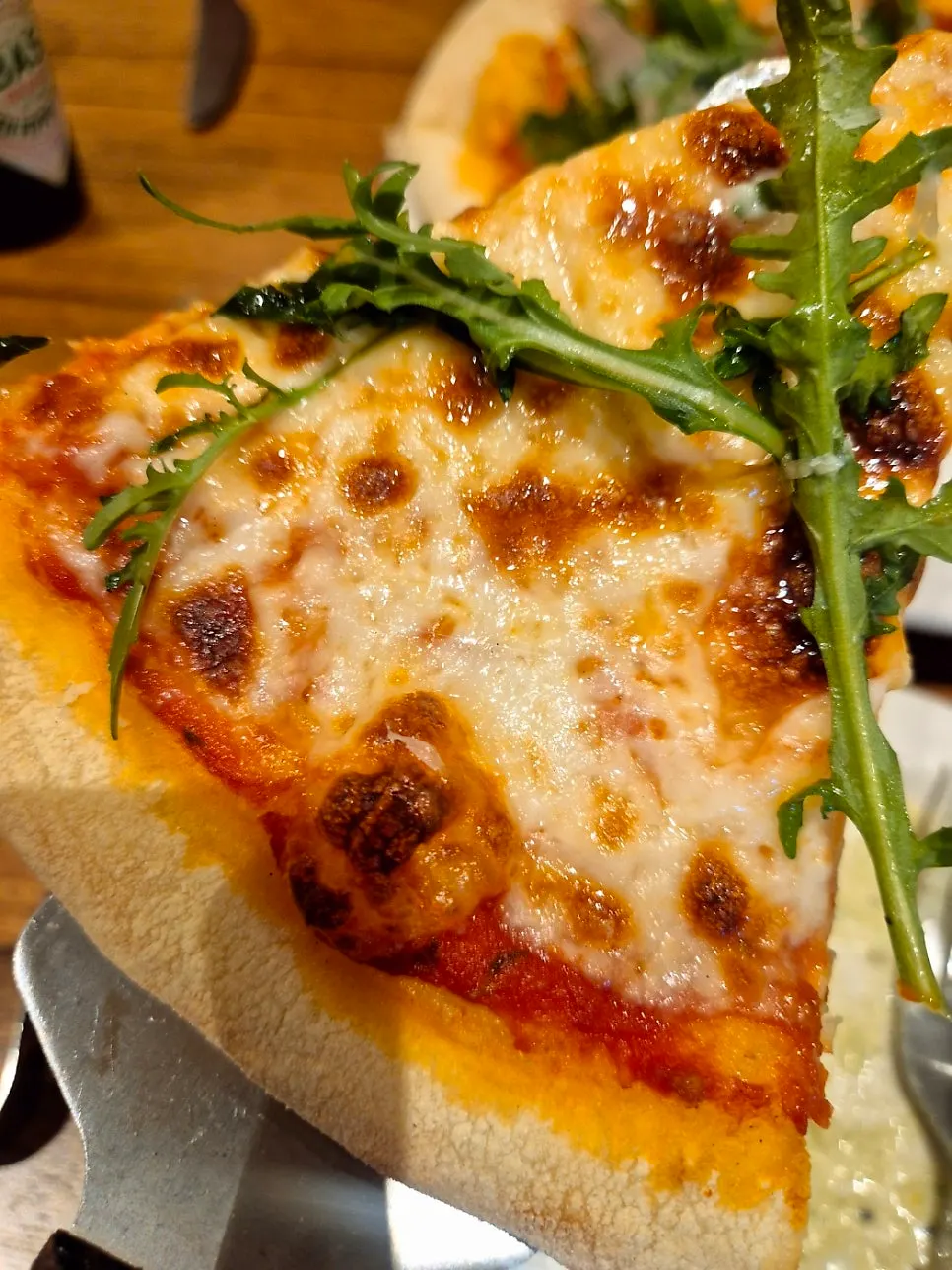 Prosciutto pizza topped with arugula