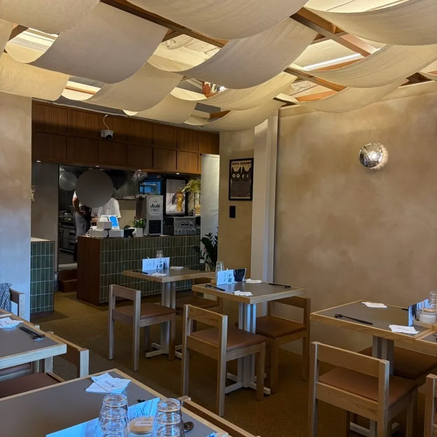Kitto's interior with fabric ceiling decor and wood tones