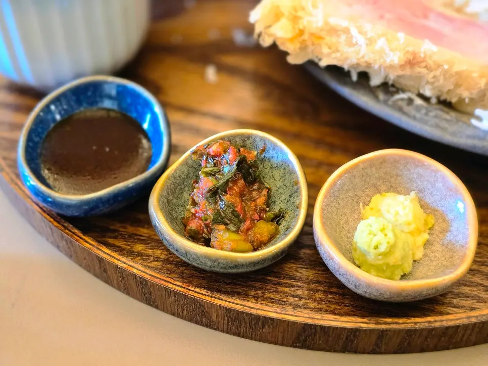 Tonkatsu sauce, gat kimchi, wasabi, and kosho served alongside the katsu