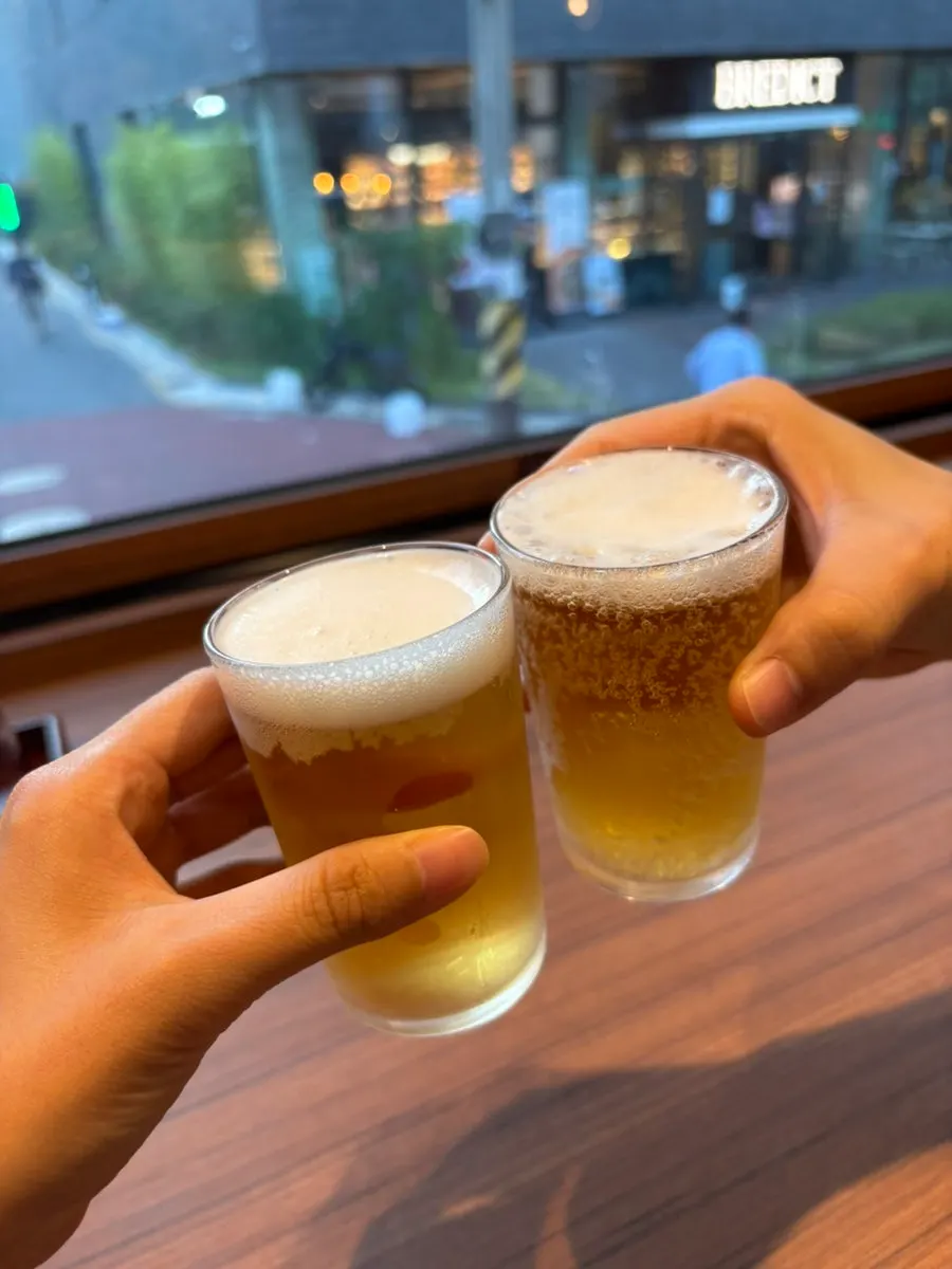 Toasting with glasses of small beer