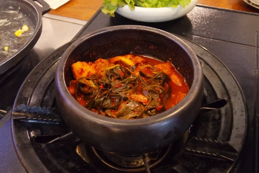 Braised green onion kimchi served with the meat