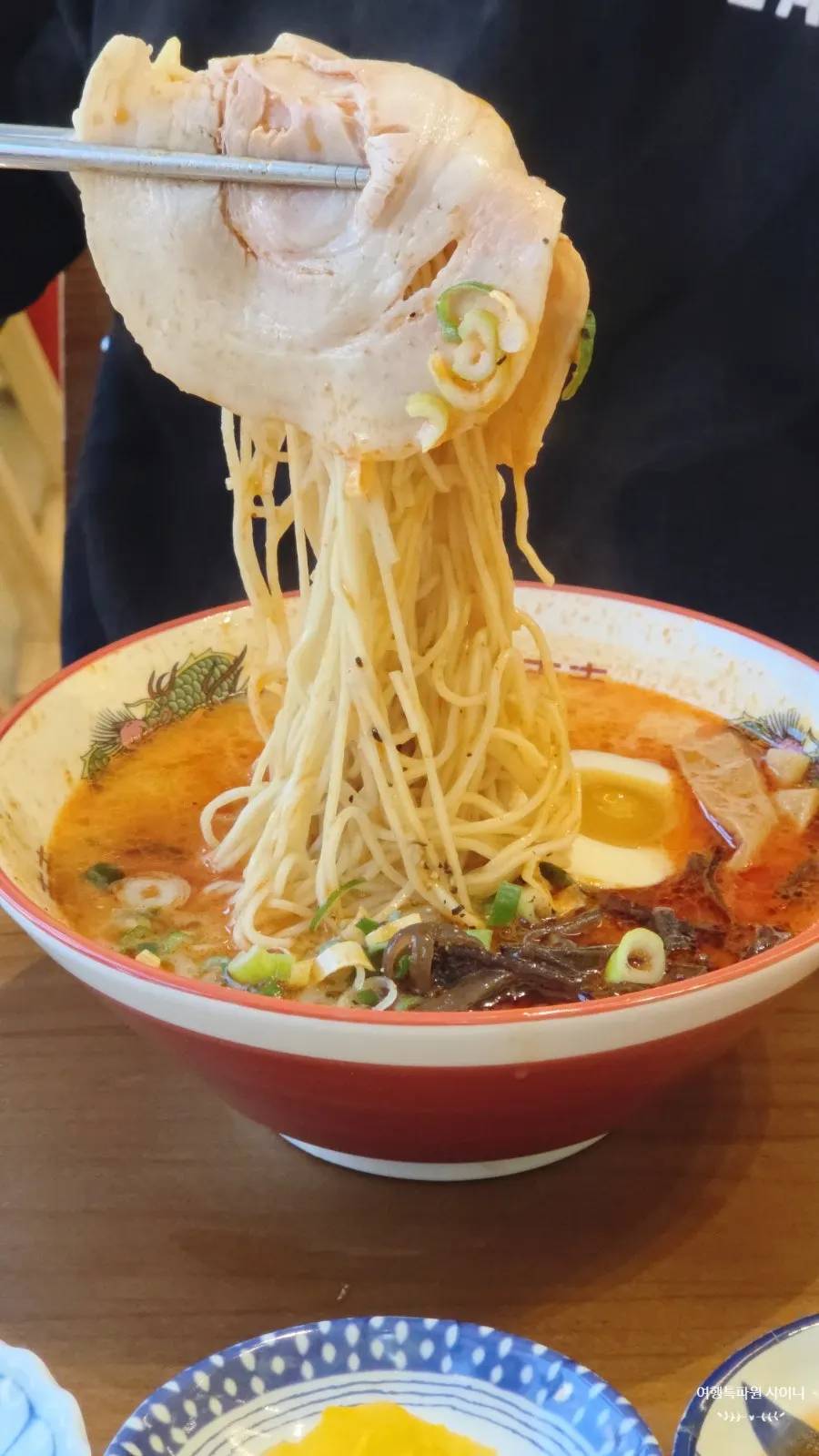 Karai ramen topped with chashu and egg