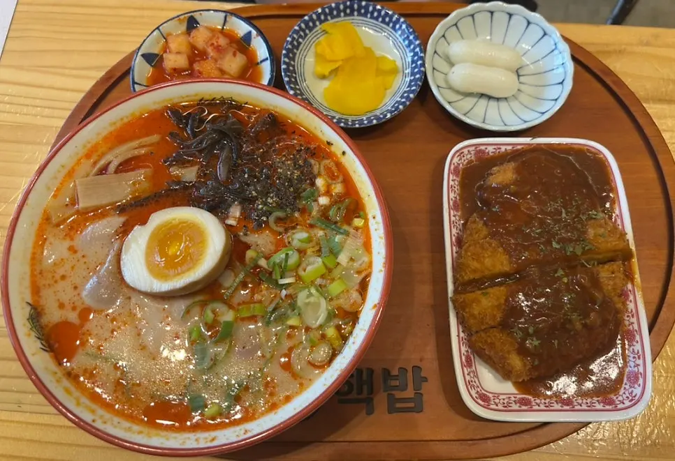 Table spread with cube steak rice bowl and spicy ramen tonkatsu set
