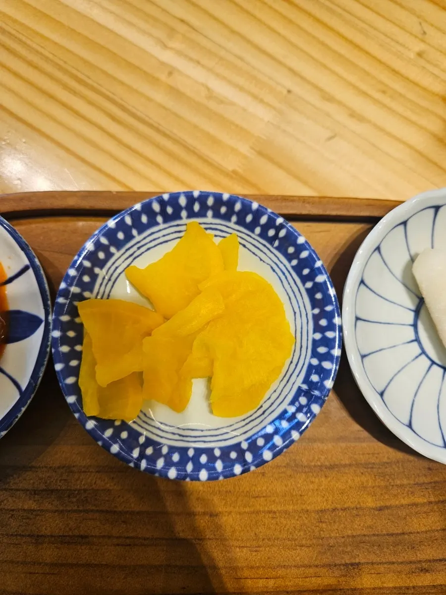 Pepper and shichimi shakers on the table
