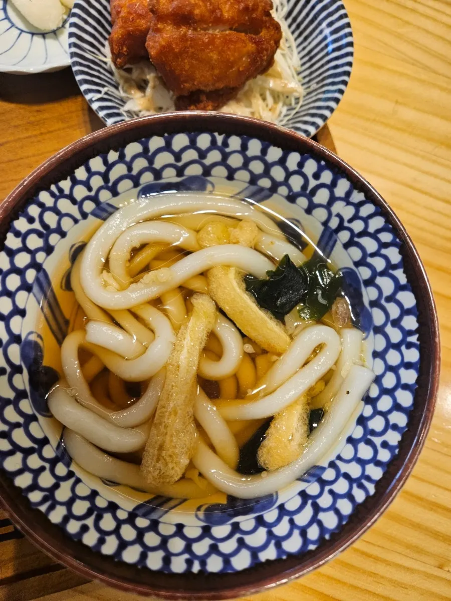 Basic side dishes of diced radish kimchi, pickled radish, and fried rice cake