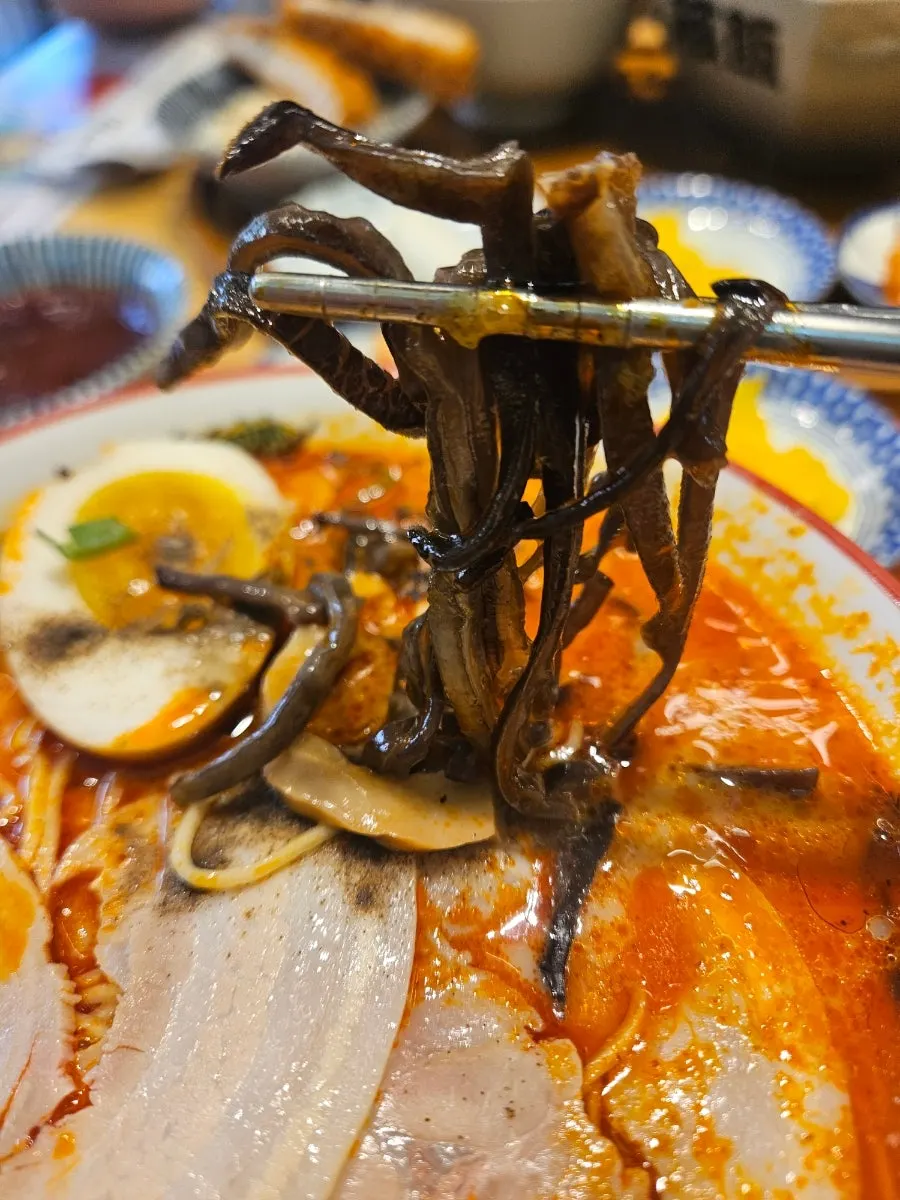 Spicy ramen broth sprinkled with pepper