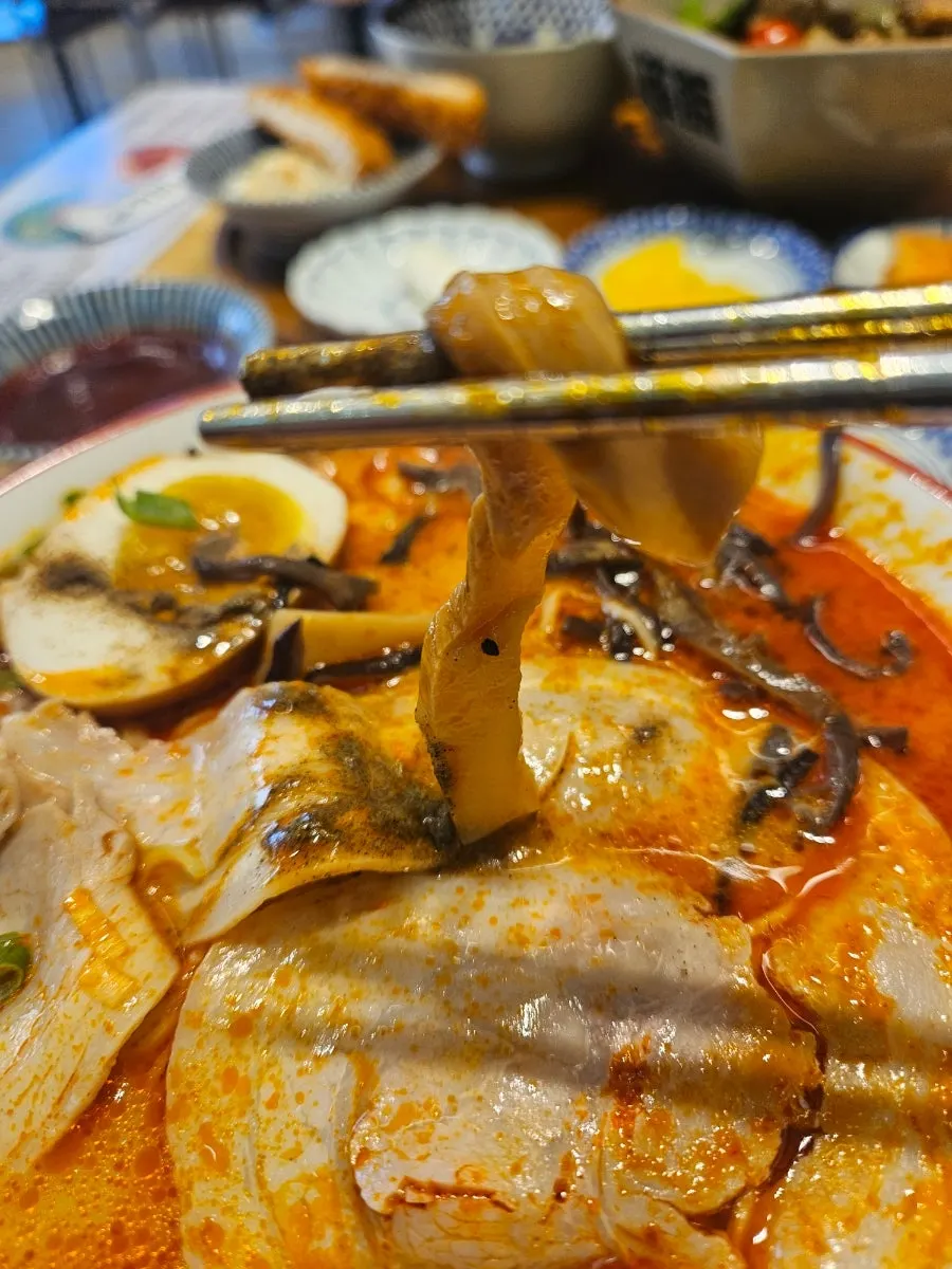 Rich tonkotsu broth of the spicy ramen