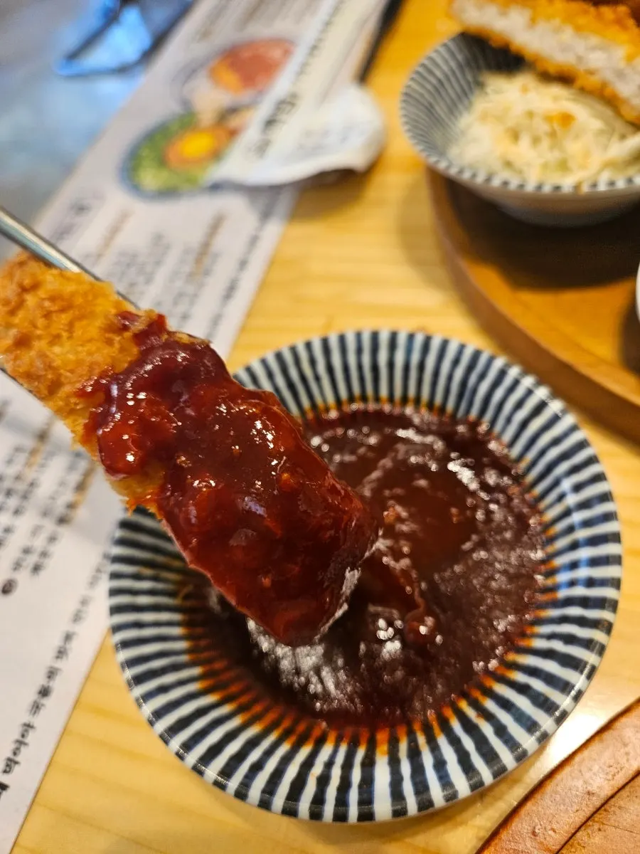 Spicy pork cutlet, fried chicken, and fried rice cake side dishes