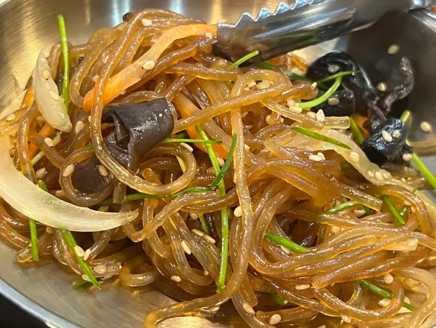 Japchae and seasoned greens side dishes