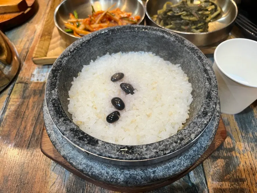 Steaming pot rice and side dishes on the table