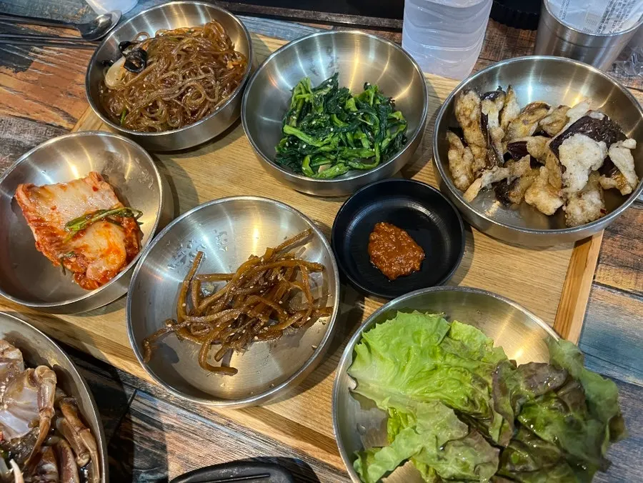 Basic banchan including seasoned vegetables, stir-fried eggplant, and japchae
