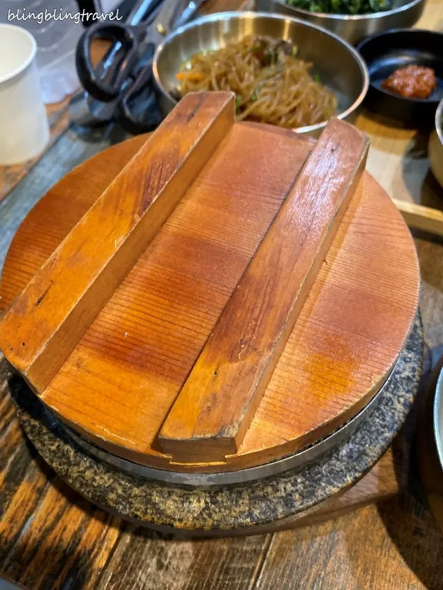 Table with cheonggukjang and cockle salad served together