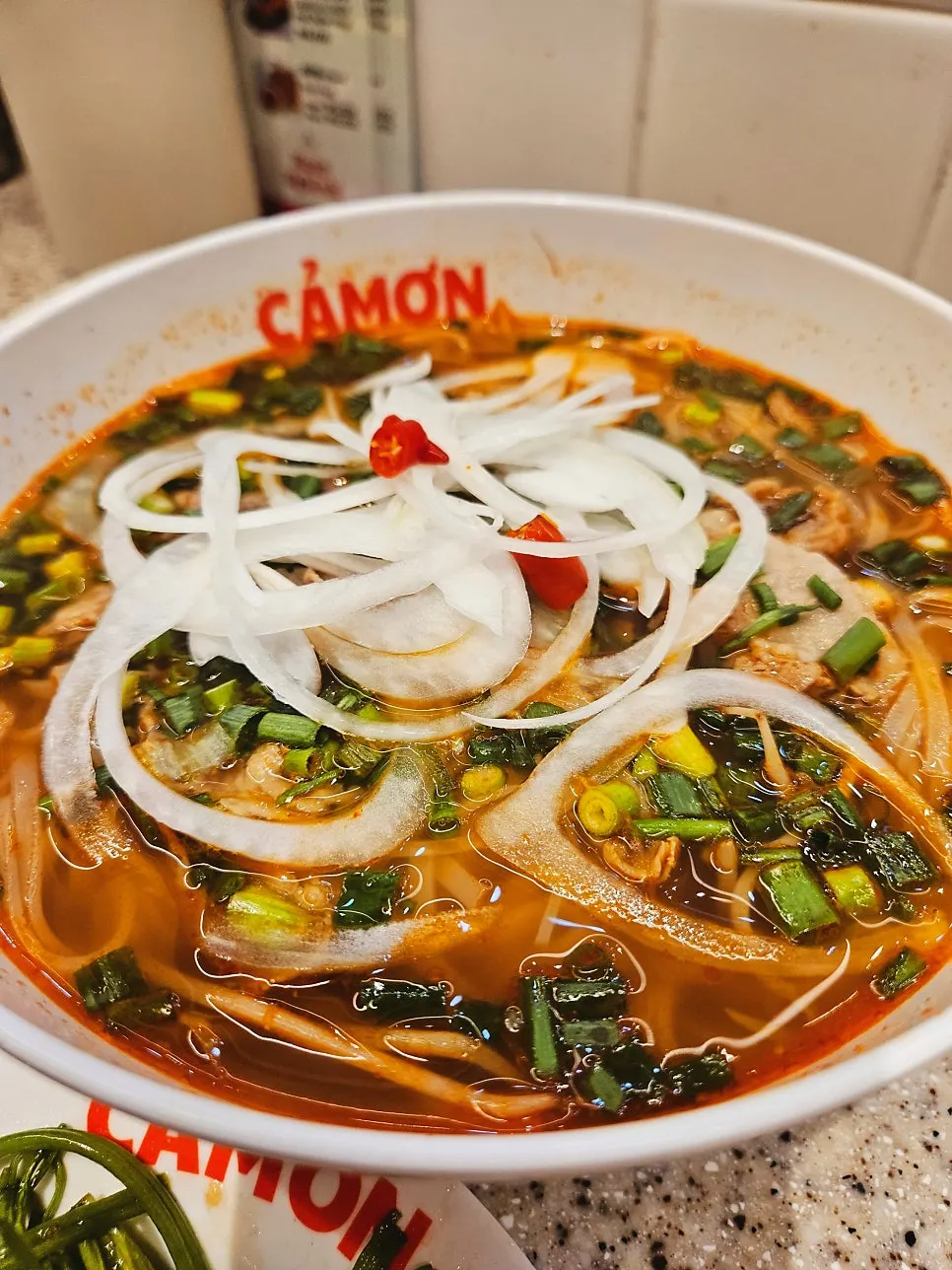 A bowl of spicy brisket pho