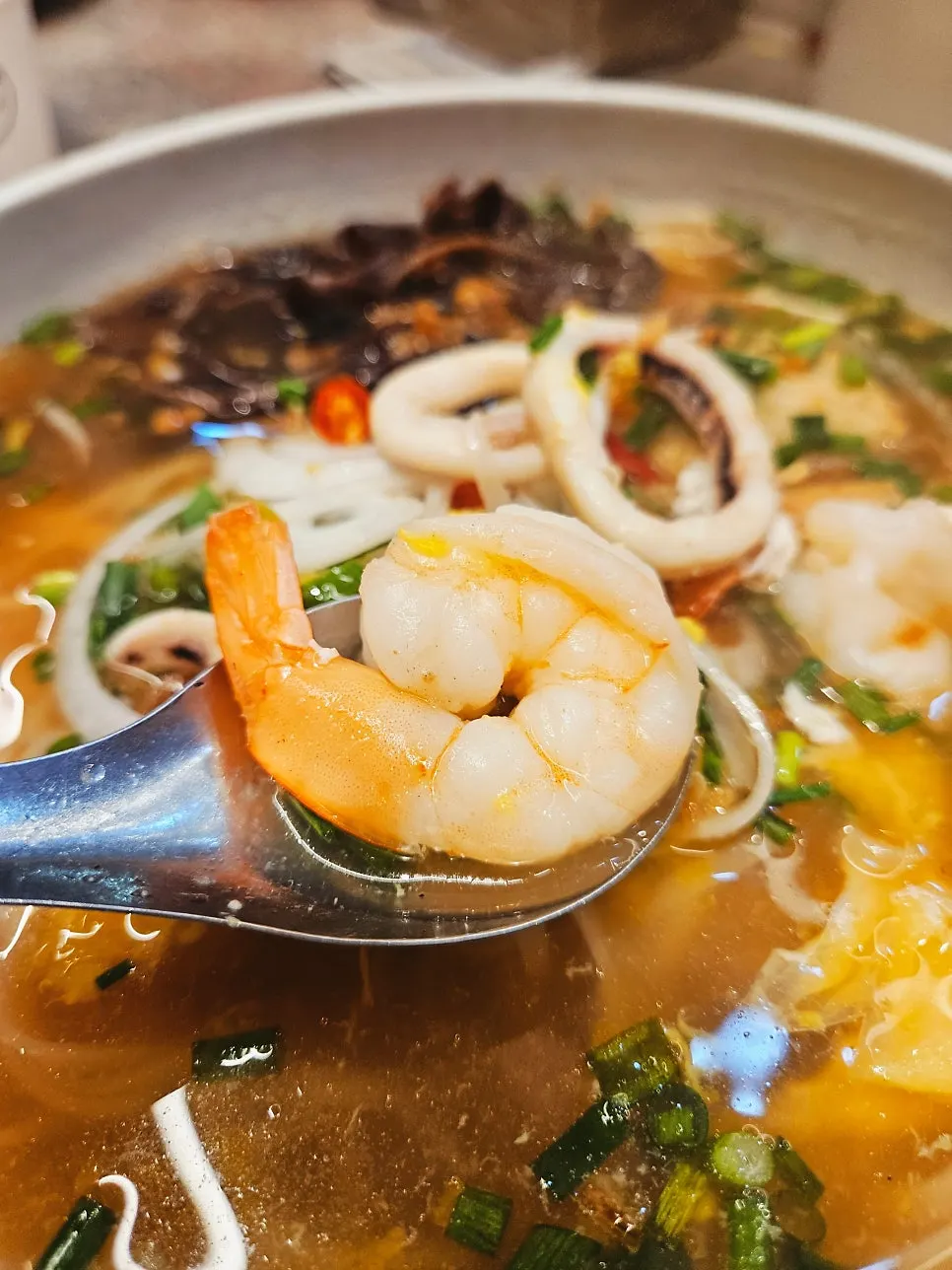Squid pho topped with squid rings and shrimp