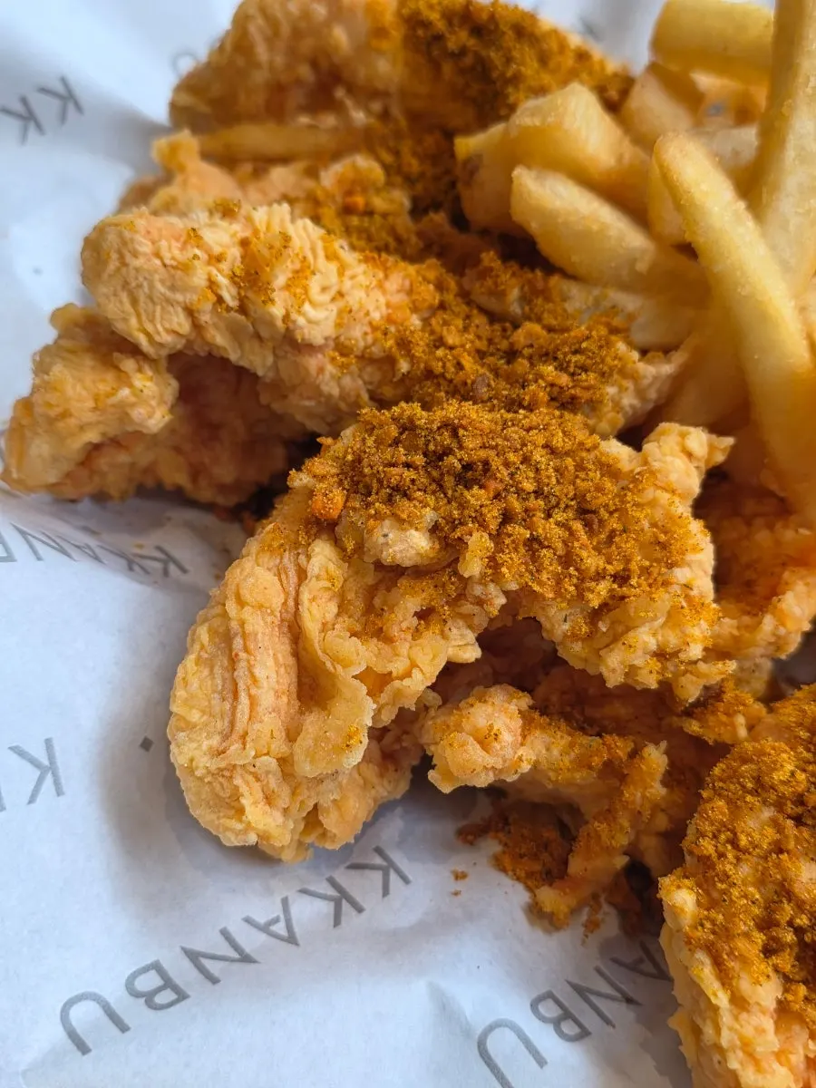 Close-up of boneless chicken topped with curry powder