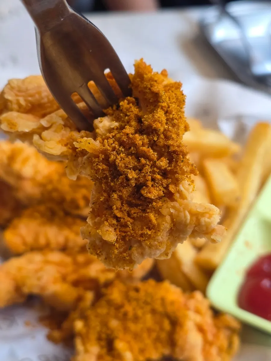 Boneless chicken split in half showing the meat inside