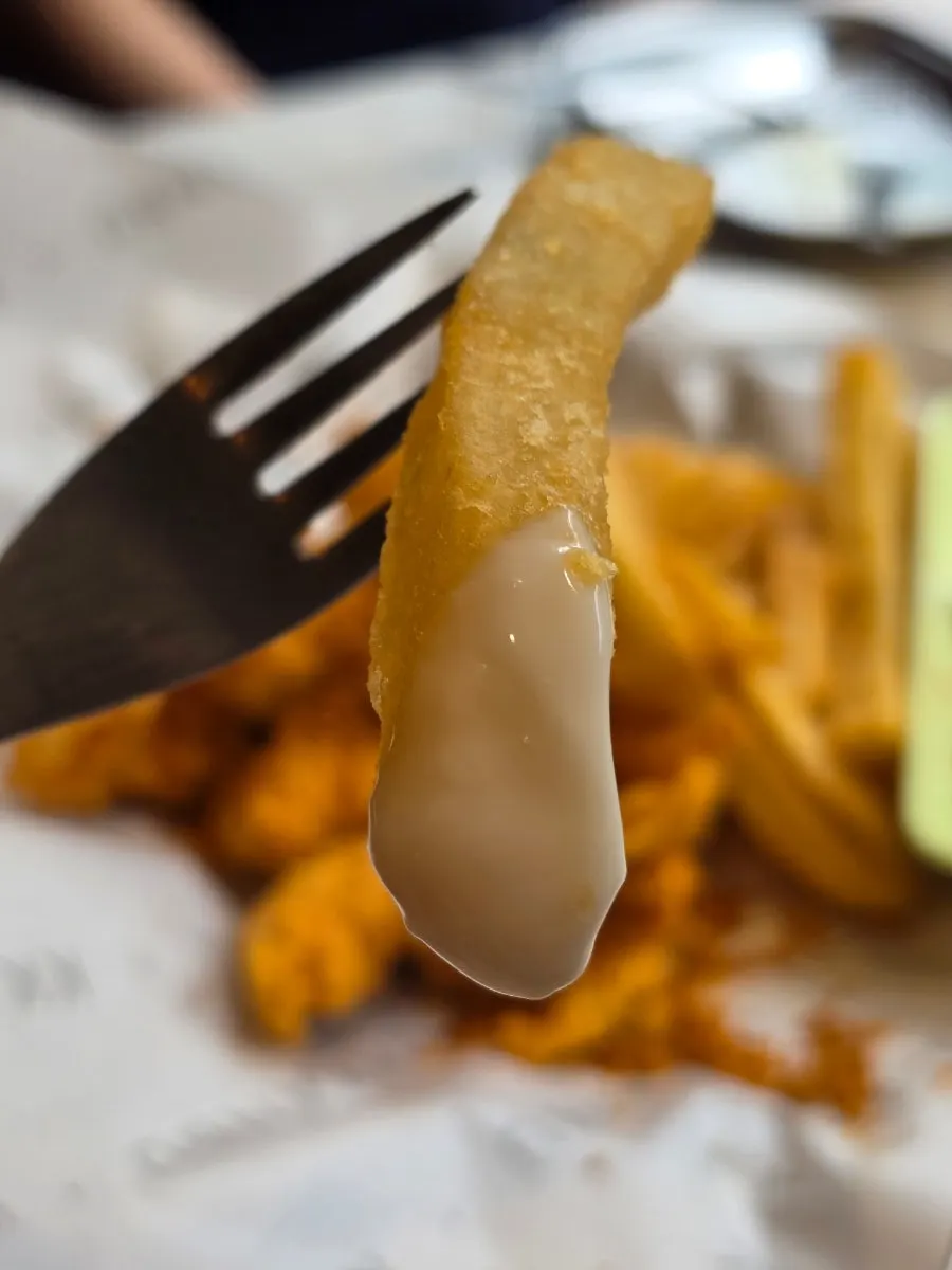 Hot fries dipped into sauce