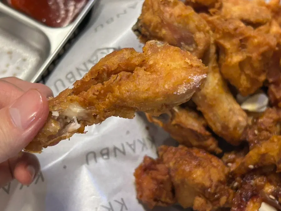 A glass of draft beer next to the chicken