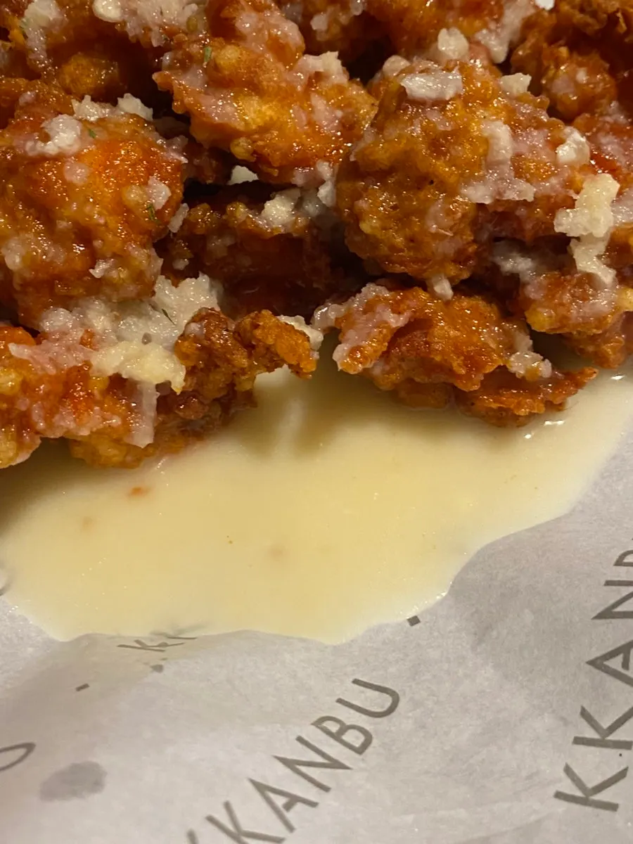 Close-up of boneless chicken piled with hand-made garlic sauce