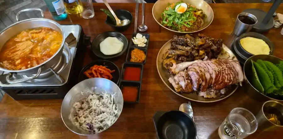 Table spread with half-and-half jjokbal and makguksu