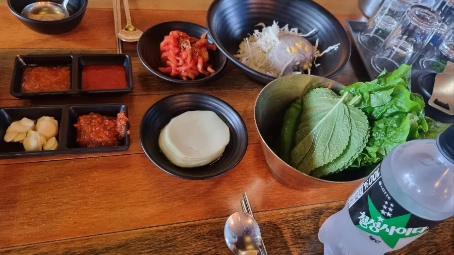 Basic side dish spread with lettuce, perilla leaves, and pickled radish